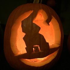 two carved pumpkins sitting on top of a table