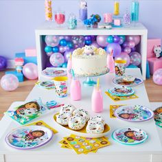 a birthday cake and party supplies on a table