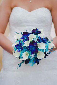 a bride holding a bouquet of blue and white flowers