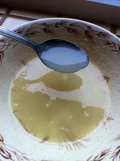 a spoon in a bowl filled with liquid