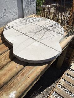 a concrete table sitting on top of a wooden bench