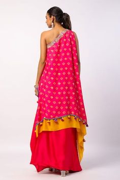 Fuchsia layered kaftan style tunic with all over flower print, hand embroidered with beads and attached tassels on hem. Paired with a solid draped skirt with pleated center front. - Aza Fashions Festival Tunic Kaftan With Floral Embroidery, Embroidered Traditional Drape Kaftan For Festivals, Diwali Embroidered Kaftan With Traditional Drape, Festive Embellished Draped Kaftan, Festival Embroidered V-neck Kaftan, Kaftan Style, Draped Skirt, Indian Designer Wear, Indian Design