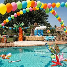 an outdoor pool decorated with balloons and decorations