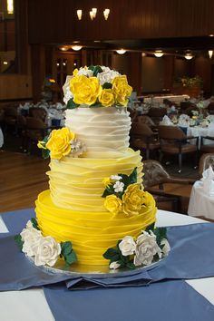 a yellow and white wedding cake with flowers on the top is featured in an instagram