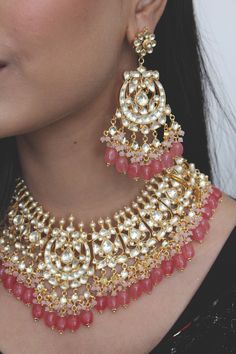 Gold Plated kundan and uncut polki set on a silver and copper alloy base. This necklace set is plated with 22k gold and embellished with semi precious rose quartz stones. Heavy necklace set with chandbaali earrings for bridal dressing.This Sabyasachi inspired necklace with a twist of coloured stones by Paisley Pop is a perfect accessory for an Indian Bride. Kundan Gold Plated Indian Bridal Jewellery with Emerald Green stones and light Pink agate stones, Semi precious Uncut Kundan Polki Indian We Pink Kundan Jewelry With Intricate Design, Fusion Style Bridal Necklace With Meenakari Chandbali, Fusion Style Meenakari Chandbali Bridal Necklace, Kundan Fusion Jewelry Sets, Festive Fusion Kundan Jewelry Sets, Festive Fusion Style Kundan Jewelry Sets, Heavy Kundan Fusion Jewelry Sets, Fusion Kundan Necklace With Meenakari For Receptions, Fusion Style Kundan Necklace With Meenakari For Reception