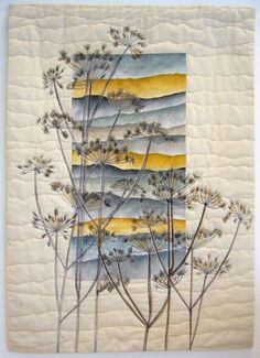 a quilted wall hanging with flowers on it's side and yellow, blue, and white stripes in the middle