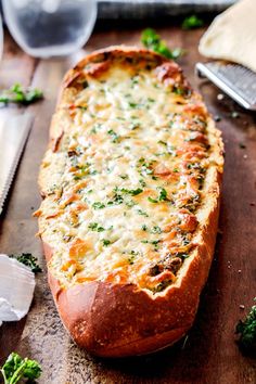 baked bread with cheese and herbs on a cutting board