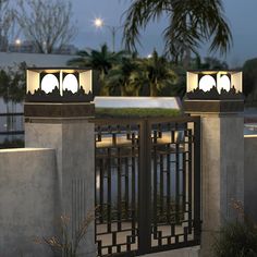 two gates with lights on each side and palm trees in the backgrouds