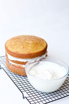 there is a cake with cream on the top and a bowl of yogurt