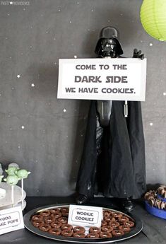 darth vader cake and star wars cookies on a table with a sign that says, come to the dark side we have cookies