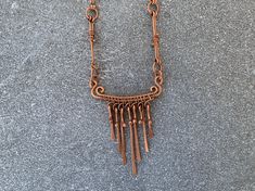 Channel your sacred source with this one of a kind statement piece. With its earthy tones and handcrafted detail, this piece reflects the mystic energy of the Yucatán’s sacred sites. This rustic necklace features a bar pendant with hammered copper dangles, intricate wire wrapping and spiral motifs. Inspired by ancient jewelry from Mesoamerica, this rustic necklace is designed to be the highlight of your ensemble.