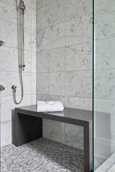 a bathroom with marble walls and flooring