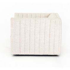 a small white couch sitting on top of a white floor