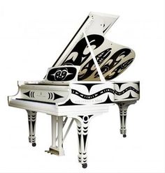 a white piano with black and white designs on it