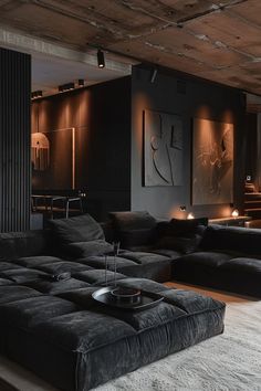 a living room filled with black furniture and candles on the wall next to a couch