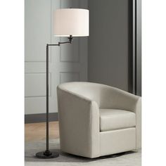 a white chair and lamp in a room