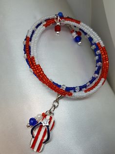 "Patriotic jewelry/Red White Blue Bracelet/Charm bracelet/ USA Jewelry This memory wire bracelet combines red, white, and blue glass beads. The darling flip flop enamel charm with Stripes and a rhinestone make it a perfect summer fit. The style is right for many patriotic occasions. The design was carefully planned to create a pleasing lay-out of the beads on your wrist. The bracelet shows like five bracelets in one in that there are five different patterns successively. It measures 36\" inches Patriotic Adjustable Dangle Jewelry, Adjustable Patriotic Jewelry With Colorful Beads, Patriotic Adjustable Colorful Beads Jewelry, Lay Out, Patriotic Jewelry, Usa Jewelry, Memory Wire Bracelet, Memory Wire Bracelets, Bracelet Charm