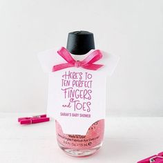 there is a small bottle with some pink things in it