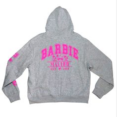 Officially Licensed Barbie Malibu Design On Front And Back. Barbie Logo On Arm. Zip Up Hoodie Sweatshirt. Ultra Soft Interior. Grey And Pink. 55% Cotton And 45% Polyester. Hh-3 Pink Long Sleeve Hoodie With Logo Print, Pink Logo Print Athleisure Sweatshirt, Pink Logo Print Sweatshirt In Athleisure Style, Pink Athleisure Sweatshirt With Logo Print, Winter Pink Sweatshirt With Logo Print, Pink Winter Hoodie With Logo Print, Casual Pink Hoodie With Logo Print, Winter Pink Hoodie With Logo Print, Malibu Design