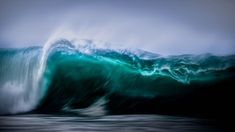 an ocean wave is breaking in the dark