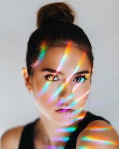 a woman with colorful lights on her face