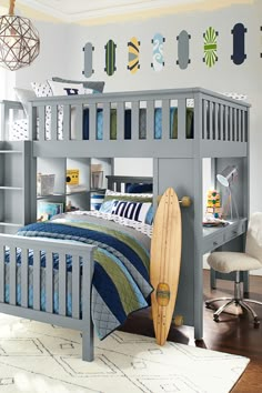 a child's bedroom with a surfboard on the bed and desk in front