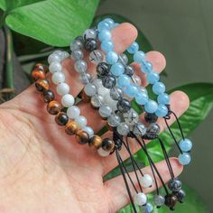 Looking for a unique and beautiful gift?  💖 Check out our crystal bracelets! Each bracelet is made of natural and unique gemstones. Whether you're looking for a special treat for yourself or a loved one, our bracelets are the perfect gift! ⭐ Material: moonstone, labradorite, black rutilated quartz, aquamarine, tiger eye ⭐ Bead size: 8mm ⭐ Bracelet size: approx  6in - 8in (adjustable) ⭐ Quantity: 1pc  🌟 There will be some color and size difference between the real items and the pictures because Spiritual Gemstone Beads Crystal Bracelet Gift, Spiritual Braided Bracelets With Round Natural Stones, Spiritual Healing Braided Bracelets With Gemstone Beads, Gemstone Crystal Bracelet As Gift, Round Gemstone Crystal Bracelet Gift, Round Crystal Gemstone Bracelet Gift, Hand-strung Round Rosary Bracelet Gift, Adjustable Gemstone Crystal Bracelet For Meditation, Adjustable Gemstone Crystal Bracelet As Gift