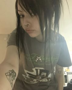 a young woman with black hair and piercings