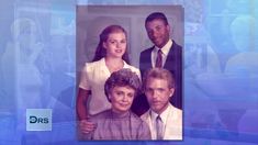 the family is posing for a photo in front of a blue background with white letters