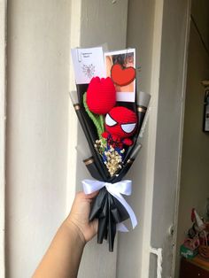 someone is holding a bouquet of flowers with pictures on it and cards attached to the stems