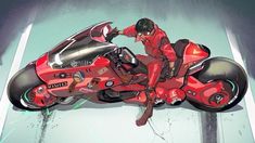 a man sitting on top of a red motorcycle