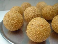 several balls of bread sitting on top of a metal pan with holes in the middle