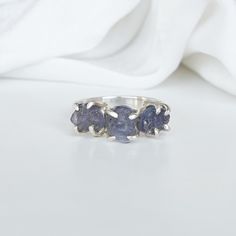 Raw Gemstone Ring - We use 925 Sterling Silver as a band - Beautiful Sterling Silver Rings with Raw Gemstones. RING DETAILS: - Gemstones: Tanzanite - Number of Pieces: 3 - Type: Uncut Natural Raw - Stone Type: 100% Natural - Stone Size: 8-12 MM - Metal: Sterling Silver 925 - Ring Setting Type: Prong For Other Ring Sizes Please Message us INSPIRATION: This Ring is inspired by mother nature. A lot of my friends and customers appreciated the raw form of Gemstones. They could somehow relate the Raw Sterling Silver Sapphire Ring With Natural Stones For Anniversary, Anniversary Sterling Silver Sapphire Ring With Natural Stones, Anniversary Sapphire Ring With Natural Stones In Sterling Silver, Handmade Tanzanite Jewelry For Anniversary, Raw Tanzanite, Raw Gemstone Ring, Ring Settings Types, Silver Handmade Jewelry, Three Stone Ring