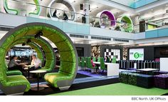 the inside of an office building with green furniture