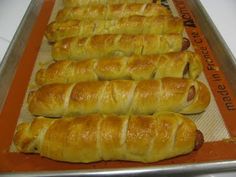 there are many croissants lined up on the baking sheet and ready to go into the oven