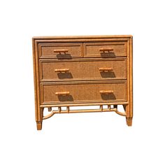 a wooden dresser with four drawers and bamboo handles on the bottom drawer, against a white background