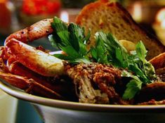 a bowl filled with meat and bread on top of a table