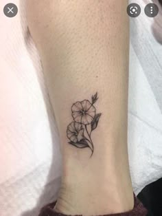 a small flower tattoo on the ankle