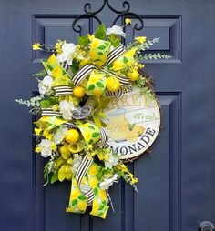 a blue door with a yellow and white wreath on it