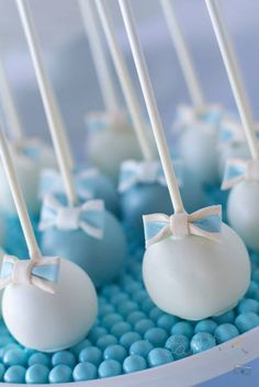 blue and white cake pops with bows on them