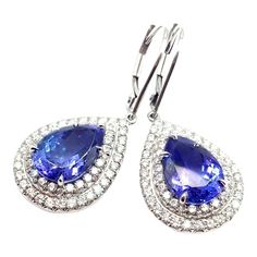 This is part of Chairish’s Fine Jewelry assortment.  Platinum Diamond Tanzanite Drop Soleste Earrings by Tiffany & Co.   With Round brilliant cut diamonds total weight approximately .51ct 2 pear shape tanzanites total weight approximately 2.50ct  These earrings are made for pieced ears.  Details:  Weight: 9.8 grams Measurements: 31mm x 13mm Stamped Hallmarks: Tiffany & Co PT950 YOUR PRICE: $11,750 T3470rtdd Pear-shaped Diamond Earrings With Gemstones, Pear-shaped Gemstone Diamond Earrings, Formal Tanzanite Teardrop Earrings, White Gold Teardrop Gemstone Diamond Earrings, Fine Jewelry Pear-shaped Earrings With Halo Setting, Louis Vuitton Earrings, Vintage Rhinestone Earrings, Starburst Earrings, Platinum Earrings