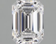 an emerald cut diamond on a gray background