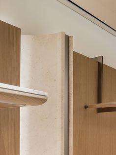 the interior of a kitchen with wooden cabinets and stainless steel handles on each door handle