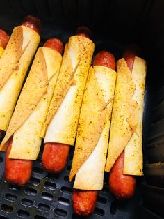 hotdogs and french fries are being cooked in an air - fryer for consumption