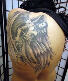 a woman's back with an angel tattoo on it