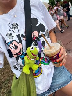 a person holding a starbucks cup and a stuffed animal