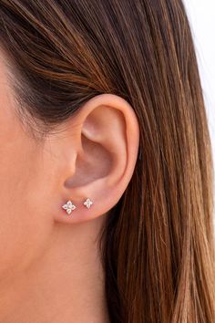 a woman's ear with three small flowers on it