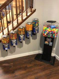 there are many different types of candy in the machine and on the wall next to the stairs