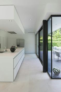 an open kitchen and dining area with large sliding glass doors