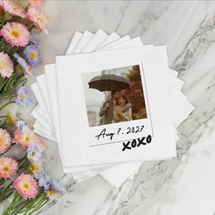 four polaroid photos are stacked on top of each other with flowers in the background